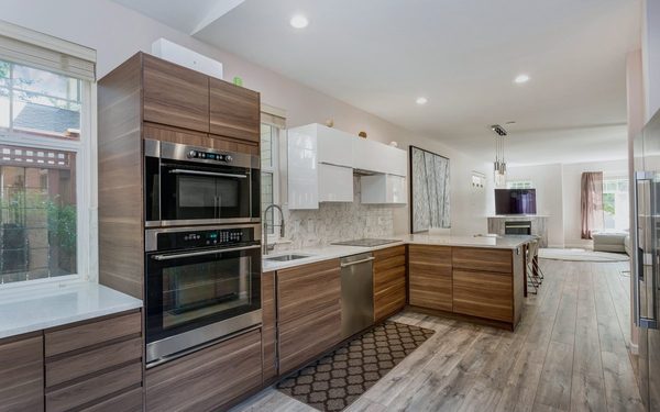 Modern wood and white kitchen with an island and full height cabinetry