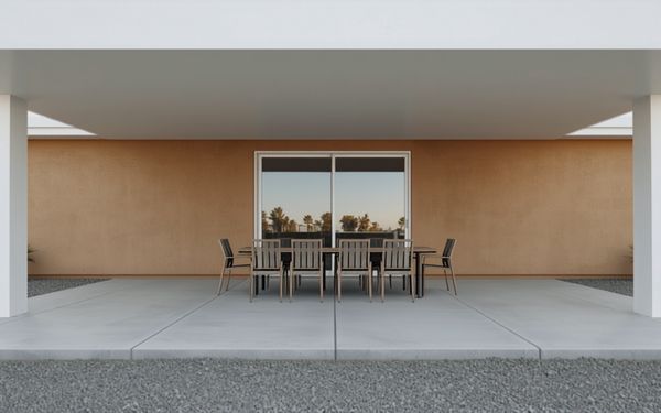 Design rendering of a covered patio behind a tan stucco house, with a flat white cover on two square white posts, a light gray concrete floor divided by straight cut lines, a sliding glass door, a long dining table with six chairs, and gray gravel in front