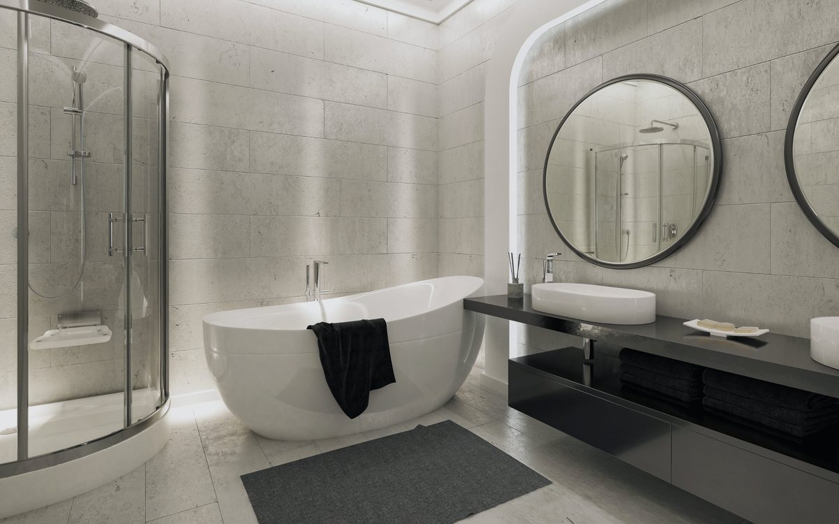 Bathroom with a freestanding tub and a glass enclosed tiled shower